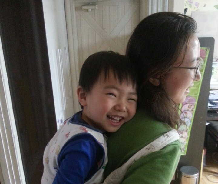 Photo of boy on mother’s back